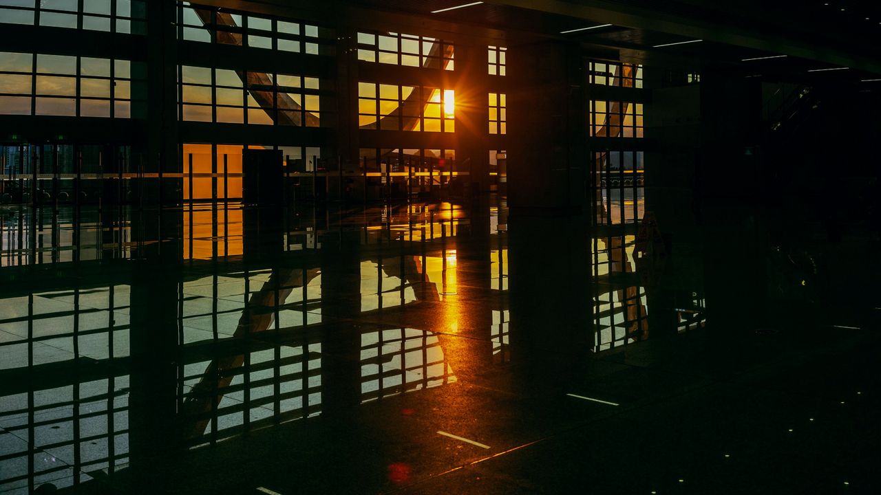 Dark office floor with golden sunset reflections